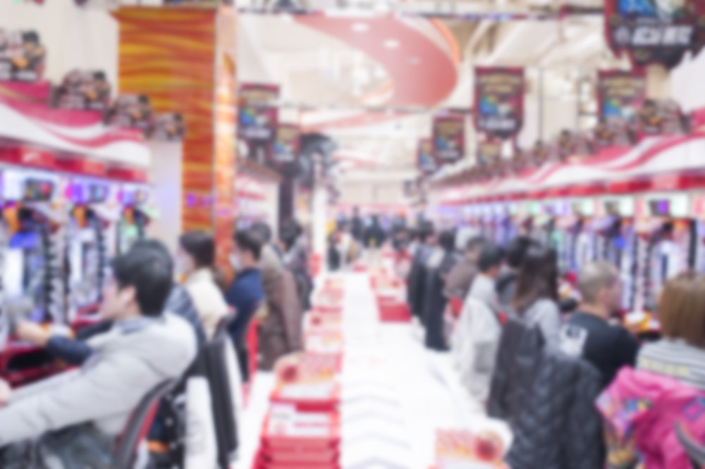 Blurred people playing Pachinko slot machine in Akihabara